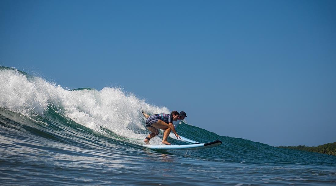 Poor surf etiquette- someone is dropping in on another surfer