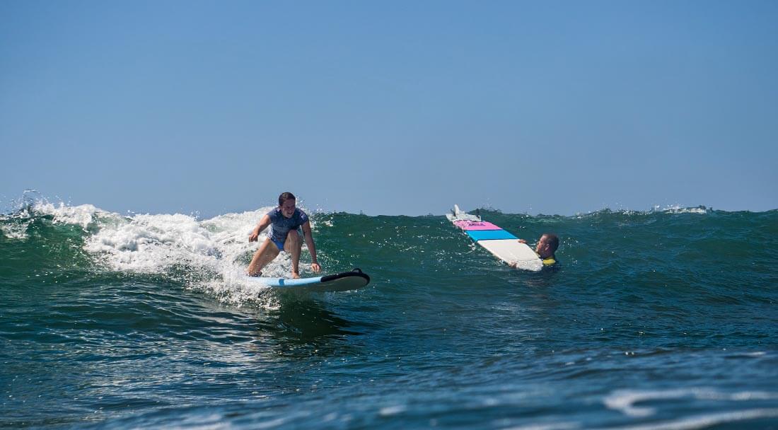 One surfer avoiding another while paddling out