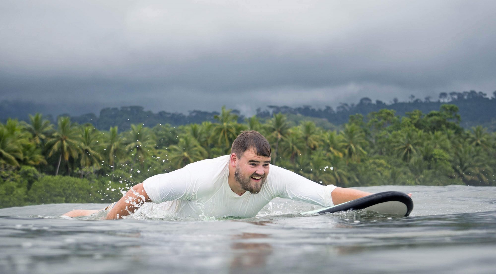 Surfer paddling out into the lineup