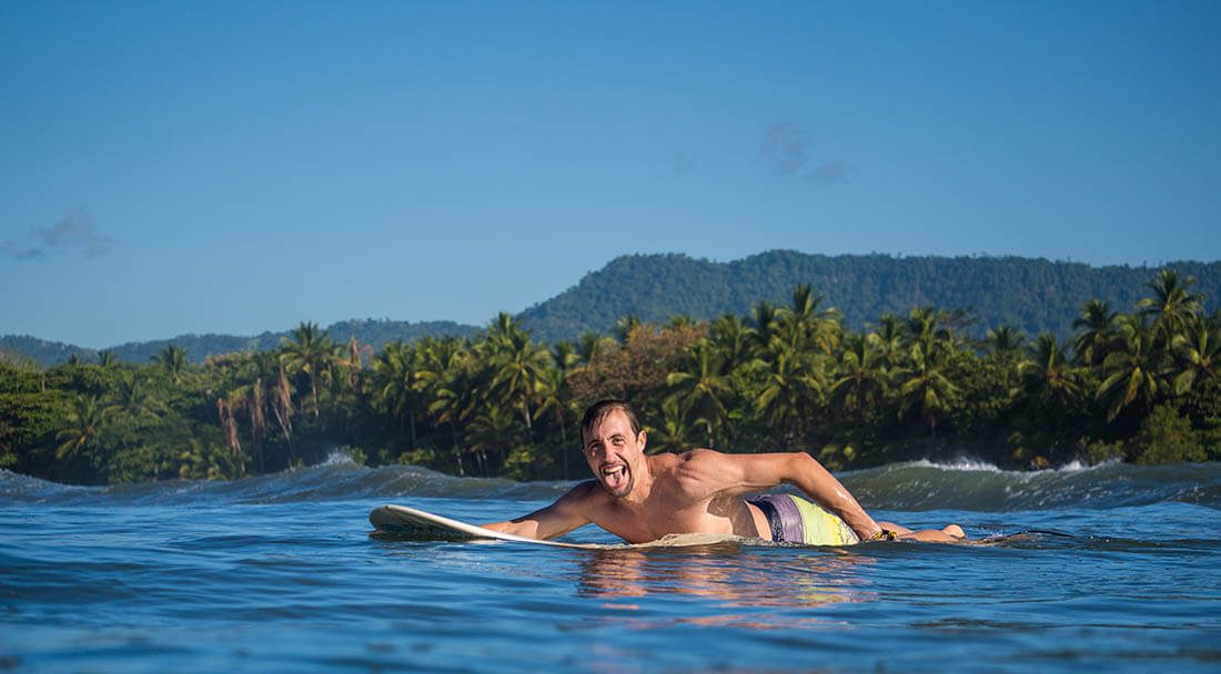 Surfer paddling with positive attitude to release happy hormones