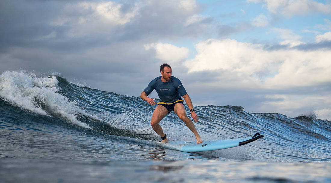 Surfer catching a bluegreen wave