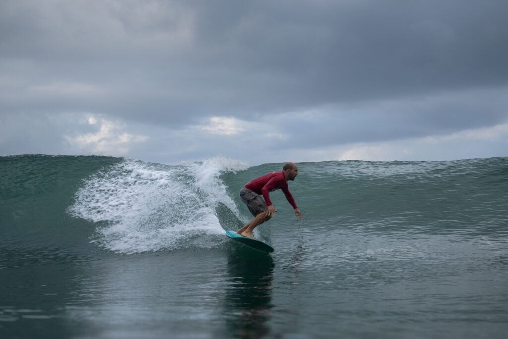 Surfing a blue-green wave in Uvita, Costa Rica