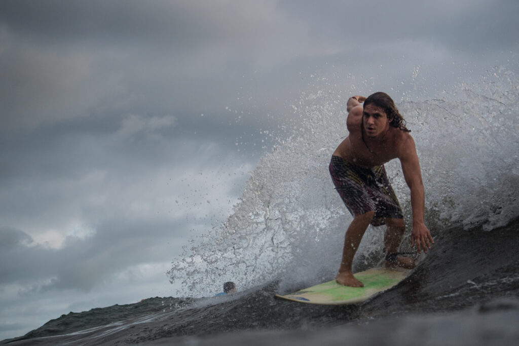 Surfing a blue-green wave in Uvita, Costa Rica