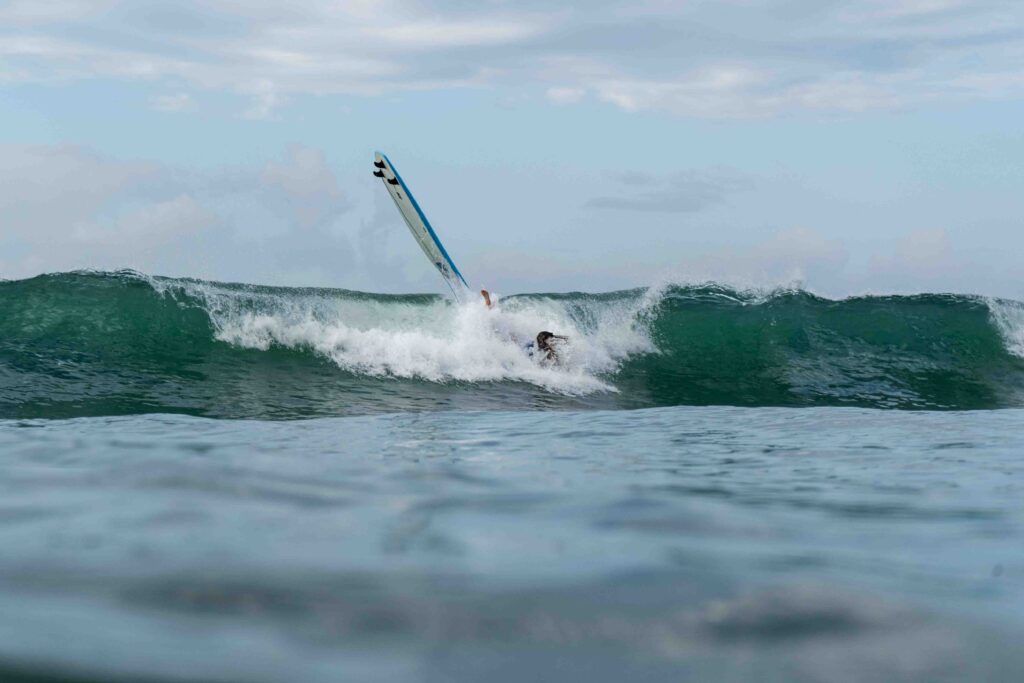 Surfer wiping out on a wave in Uvita, Costa Rica