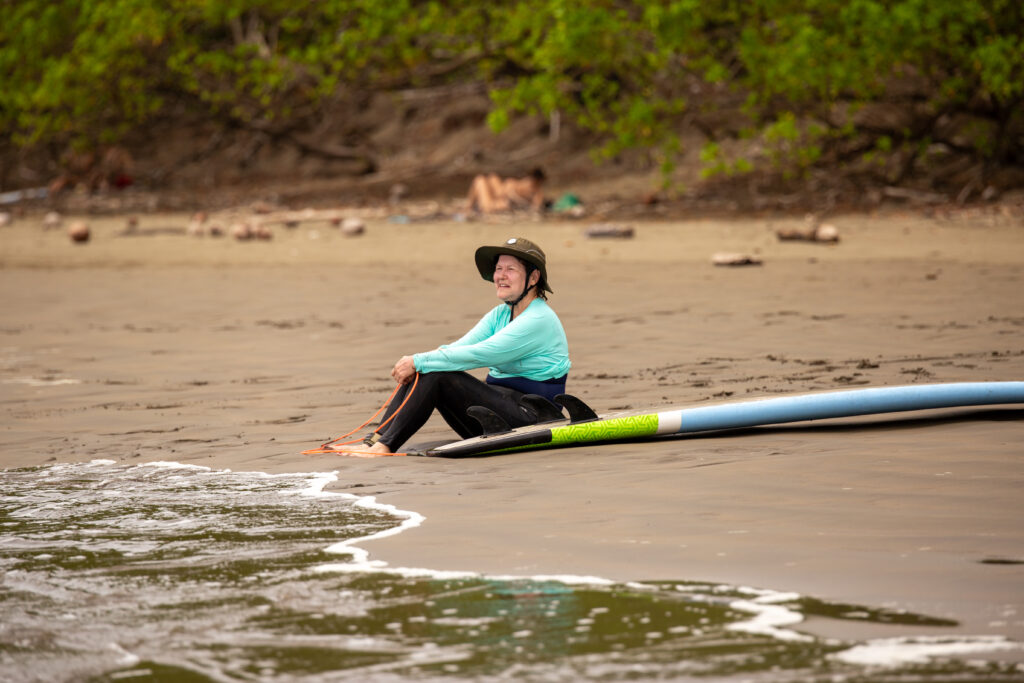 Sitting on the beach during a surf lesson at the Marino Ballena National Park